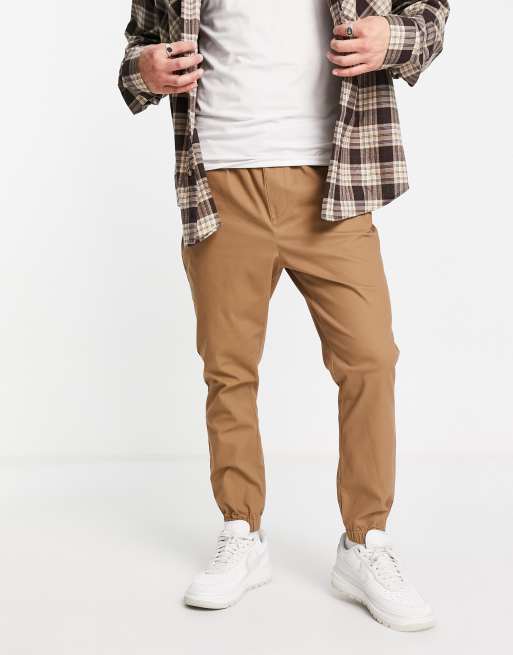 ASOS DESIGN tapered chino trackies with elasticated waist in stone