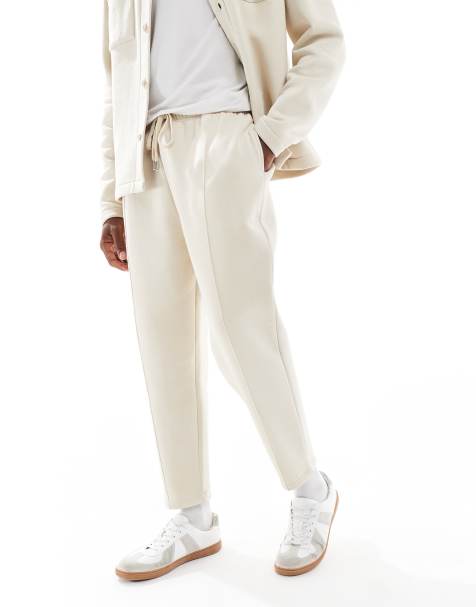 ASOS DESIGN tapered fit fixed hem trackies with pleats in stone - view 1