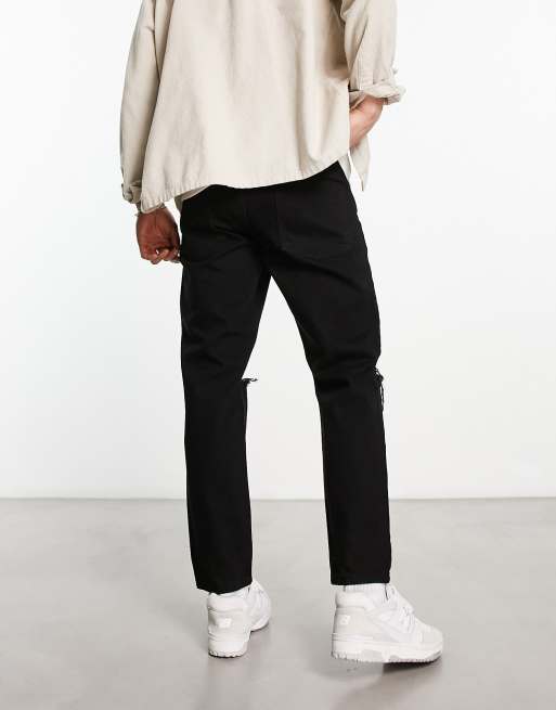 ASOS DESIGN tapered fit jeans in black wash with knee rips , 2 of 4