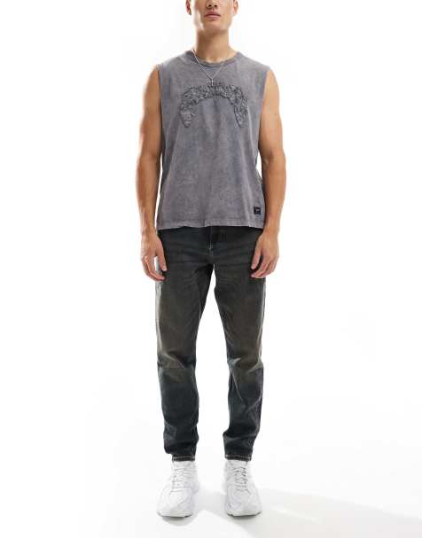 ASOS DESIGN tapered fit jeans in dark wash blue with tint - view 1