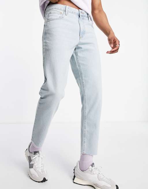 ASOS DESIGN tapered fit jeans in light blue wash with raw hem - MBLUE