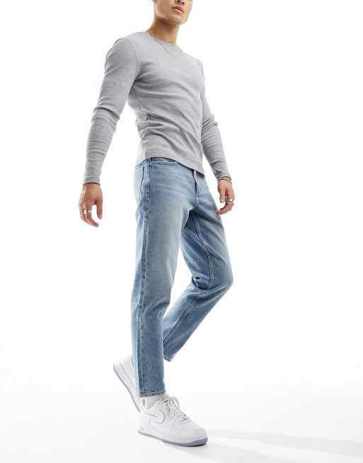 ASOS DESIGN tapered fit jeans in light blue wash