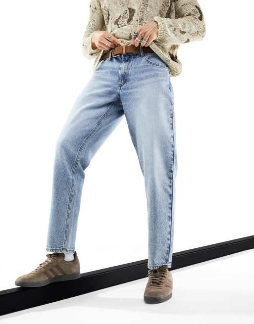 ASOS DESIGN tapered fit jeans in light wash blue