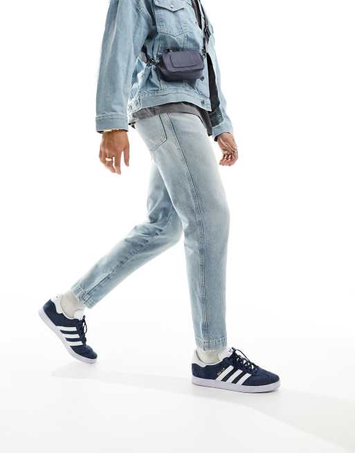 ASOS DESIGN tapered fit jeans in light wash blue