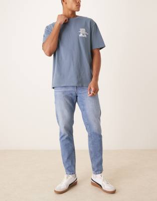 ASOS DESIGN tapered fit jeans in light wash blue 7590₽