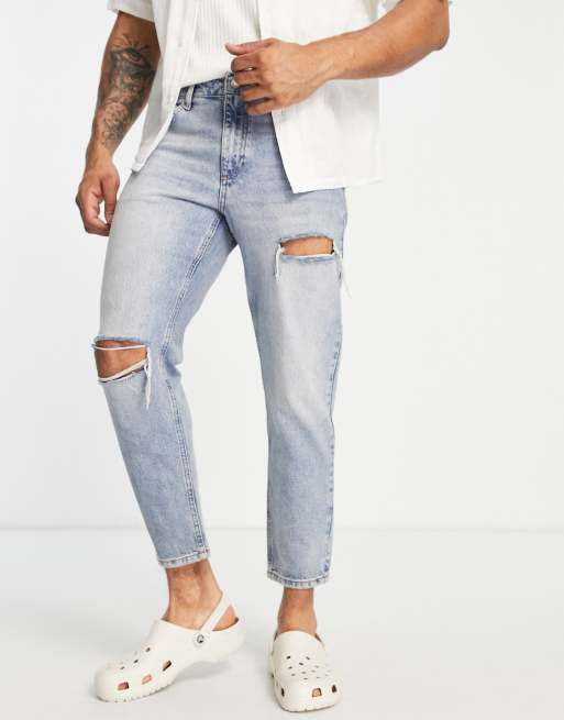 ASOS DESIGN tapered fit jeans in mid wash blue with tint and rips  - MBLUE