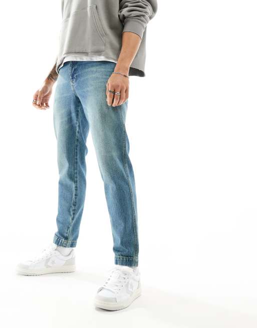 ASOS DESIGN tapered fit jeans in tinted mid wash blue