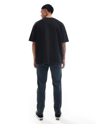 ASOS DESIGN tapered fit jeans in washed gray with green tint 