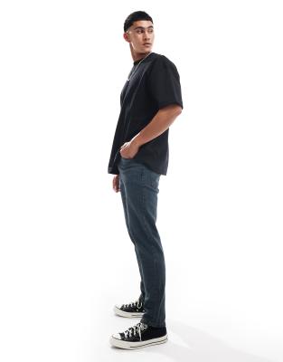 ASOS DESIGN tapered fit jeans in washed gray with green tint 