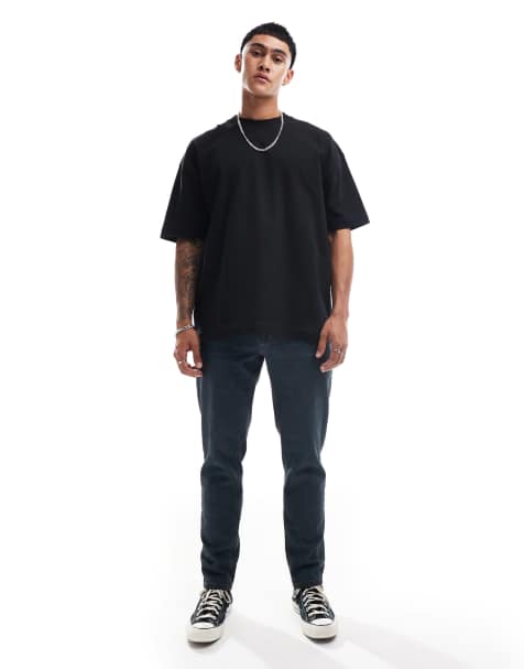 ASOS DESIGN tapered fit jeans in washed grey with green tint - view 1
