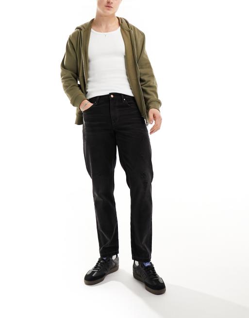 ASOS DESIGN tapered fit jeans with abrasions in washed black 