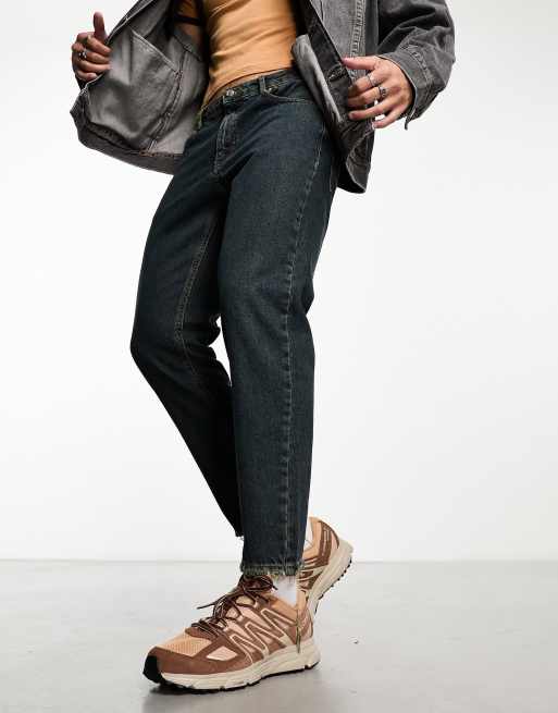 ASOS DESIGN tapered fit jeans with distressed hem in dark vintage tint - MBLUE
