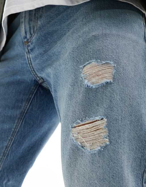 ASOS DESIGN tapered fit jeans with rips in light wash blue , 2 of 5