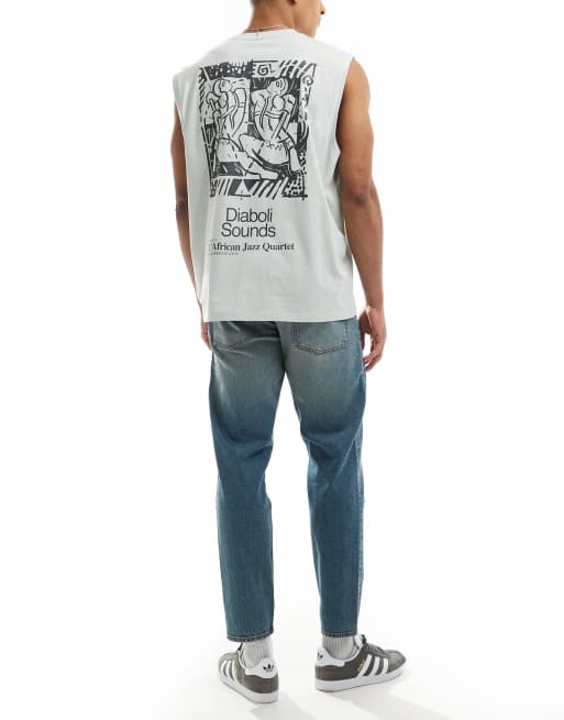 ASOS DESIGN tapered fit jeans with tint in light wash blue, 2 of 5