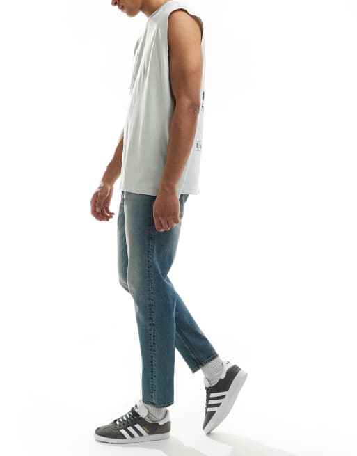 ASOS DESIGN tapered fit jeans with tint in light wash blue, 3 of 5