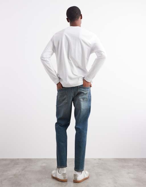 ASOS DESIGN tapered fit jeans with tint in mid wash blue, 2 of 5
