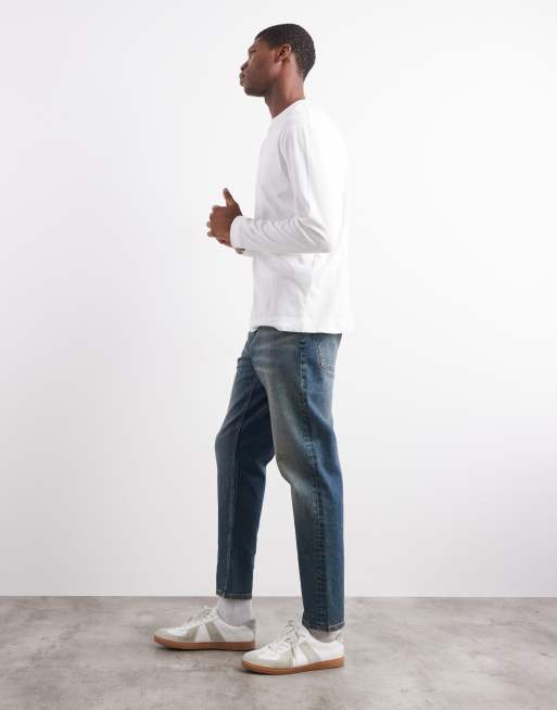 ASOS DESIGN tapered fit jeans with tint in mid wash blue, 3 of 5