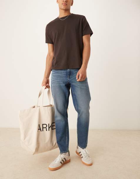 ASOS DESIGN tapered fit jeans with vintage tint in light wash blue - view 1