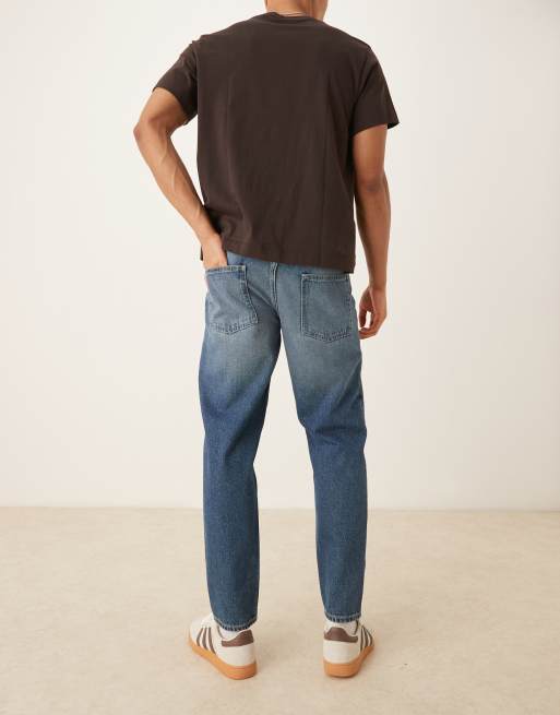 ASOS DESIGN tapered fit jeans with vintage tint in light wash blue