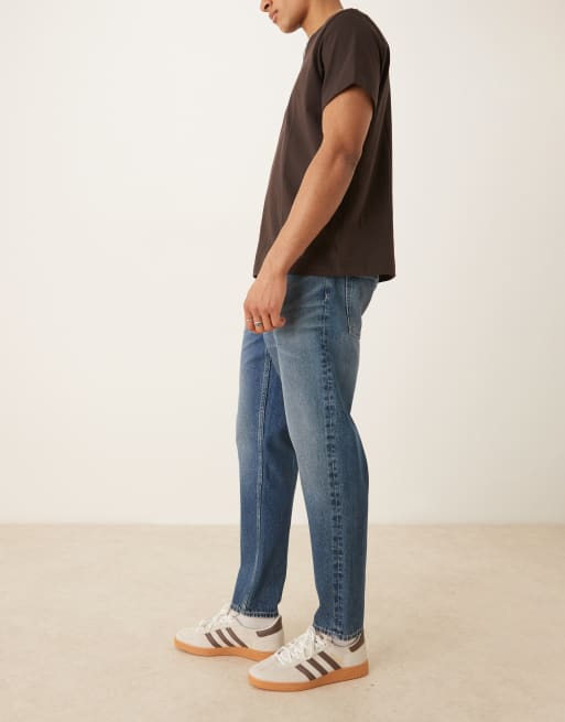 ASOS DESIGN tapered fit jeans with vintage tint in light wash blue, 3 of 5