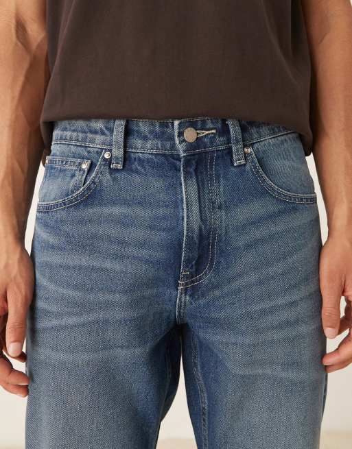 ASOS DESIGN tapered fit jeans with vintage tint in light wash blue