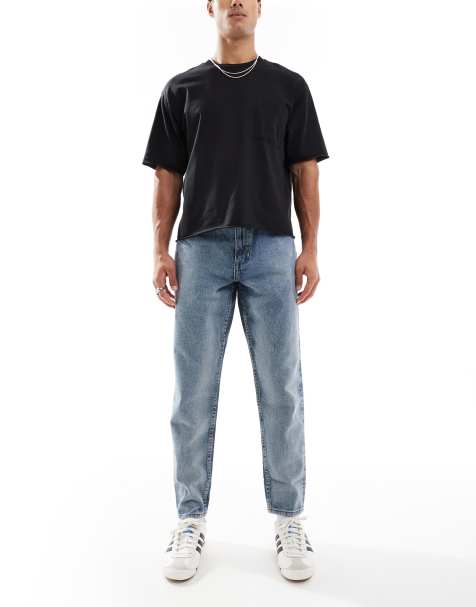 ASOS DESIGN tapered fit jeans with vintage tint in mid wash blue - view 1