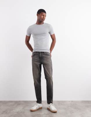 Asos Design Tapered Fit Jeans With Yellow Tint In Black