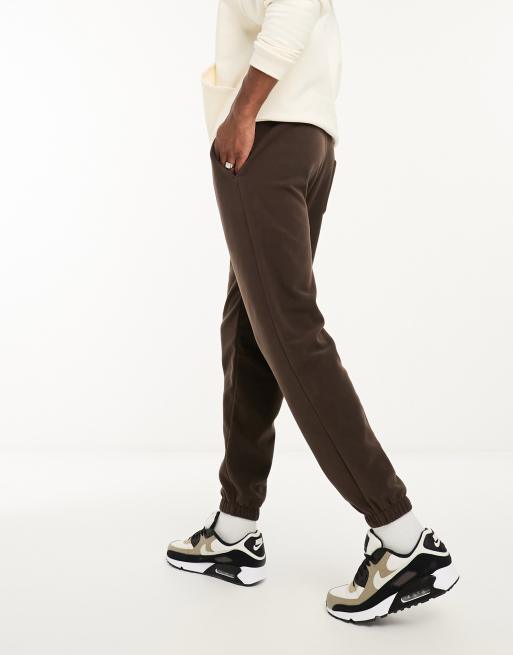 ASOS DESIGN tapered fleece joggers in brown