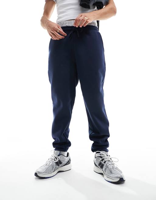 ASOS DESIGN tapered heavyweight trackies in navy