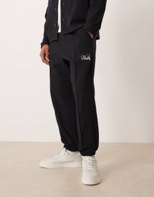 Asos Design Tapered Jacquard Sweatpants With Embroidery In Black