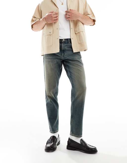 ASOS DESIGN - Tapered jeans i blå mellemvask