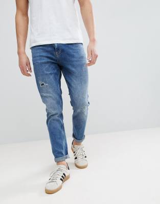 ASOS DESIGN tapered jeans in dark wash with rip & repair-Blue