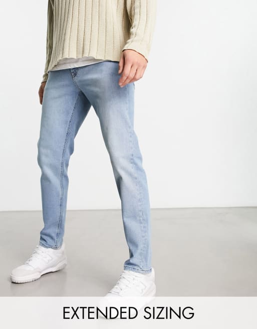 Asos design tapered jeans with curved store seams and belt in washed black