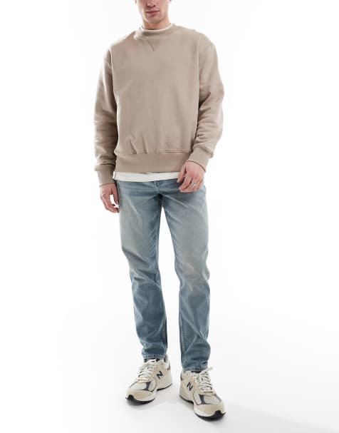 ASOS DESIGN tapered jeans in light wash blue - view 1