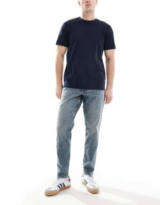 ASOS DESIGN tapered jeans in light wash blue