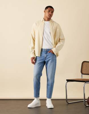 ASOS DESIGN tapered jeans in light wash blue