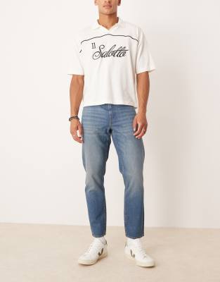ASOS DESIGN tapered jeans in light wash blue - view 1