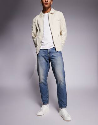ASOS DESIGN tapered jeans in mid wash blue tint