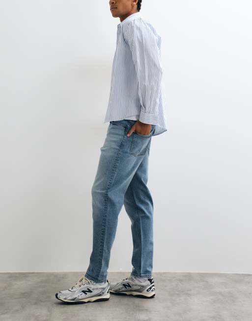 ASOS DESIGN tapered jeans in mid wash blue with tint, 2 of 5