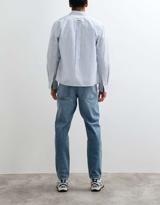 ASOS DESIGN tapered jeans in mid wash blue with tint, 3 of 5