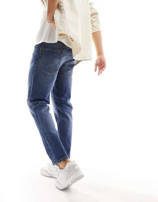 ASOS DESIGN tapered jeans in light wash blue