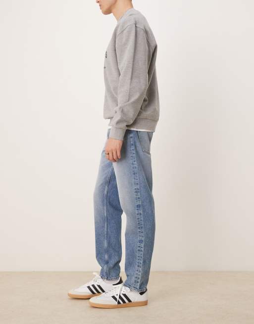 ASOS DESIGN tapered jeans in mid wash blue, 2 of 5