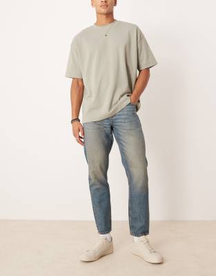 ASOS DESIGN tapered jeans in mid wash blue - view 1