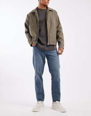 ASOS DESIGN tapered jeans in mid wash blue