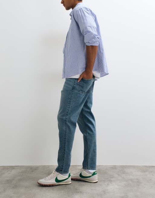 ASOS DESIGN tapered jeans in mid wash blue, 2 of 5