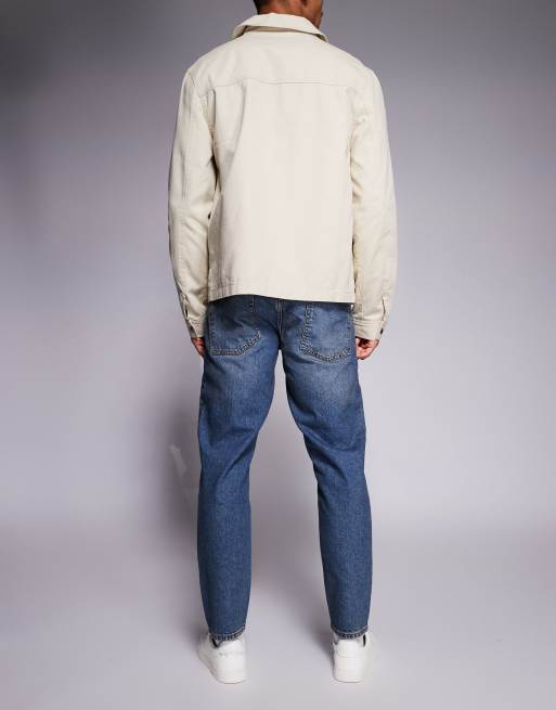 ASOS DESIGN tapered jeans in mid wash with tint