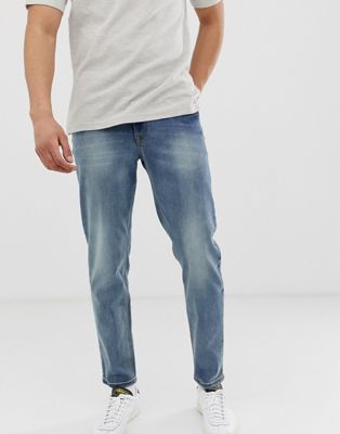 ASOS DESIGN tapered jeans in mid wash 