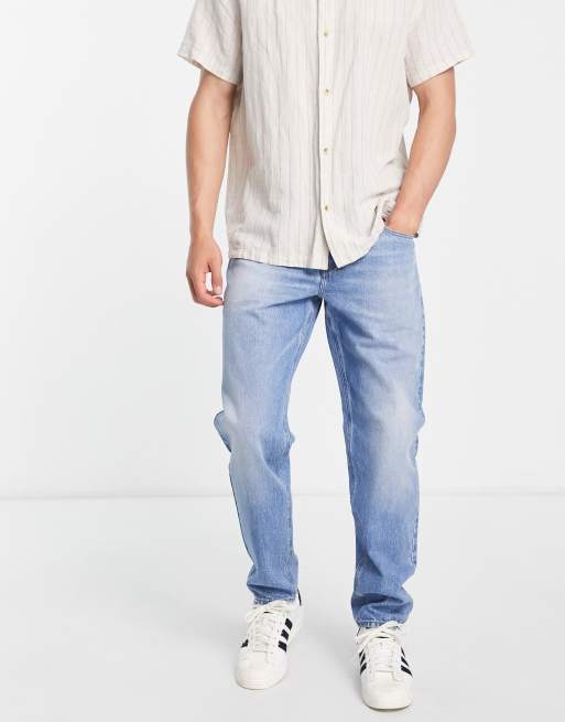 ASOS DESIGN tapered jeans in tinted light wash blue