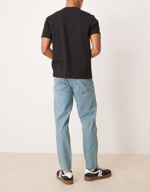 ASOS DESIGN tapered jeans in tinted light wash blue 