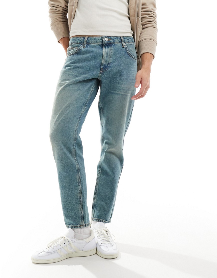 ASOS DESIGN tapered jeans in tinted light wash blue